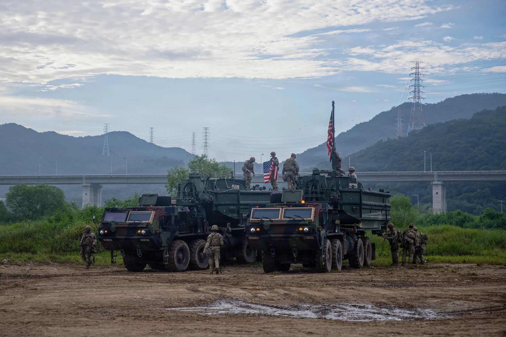 Soldiers preparing bridge erection boats on heavy trucks for a river-crossing exercise in South Korea