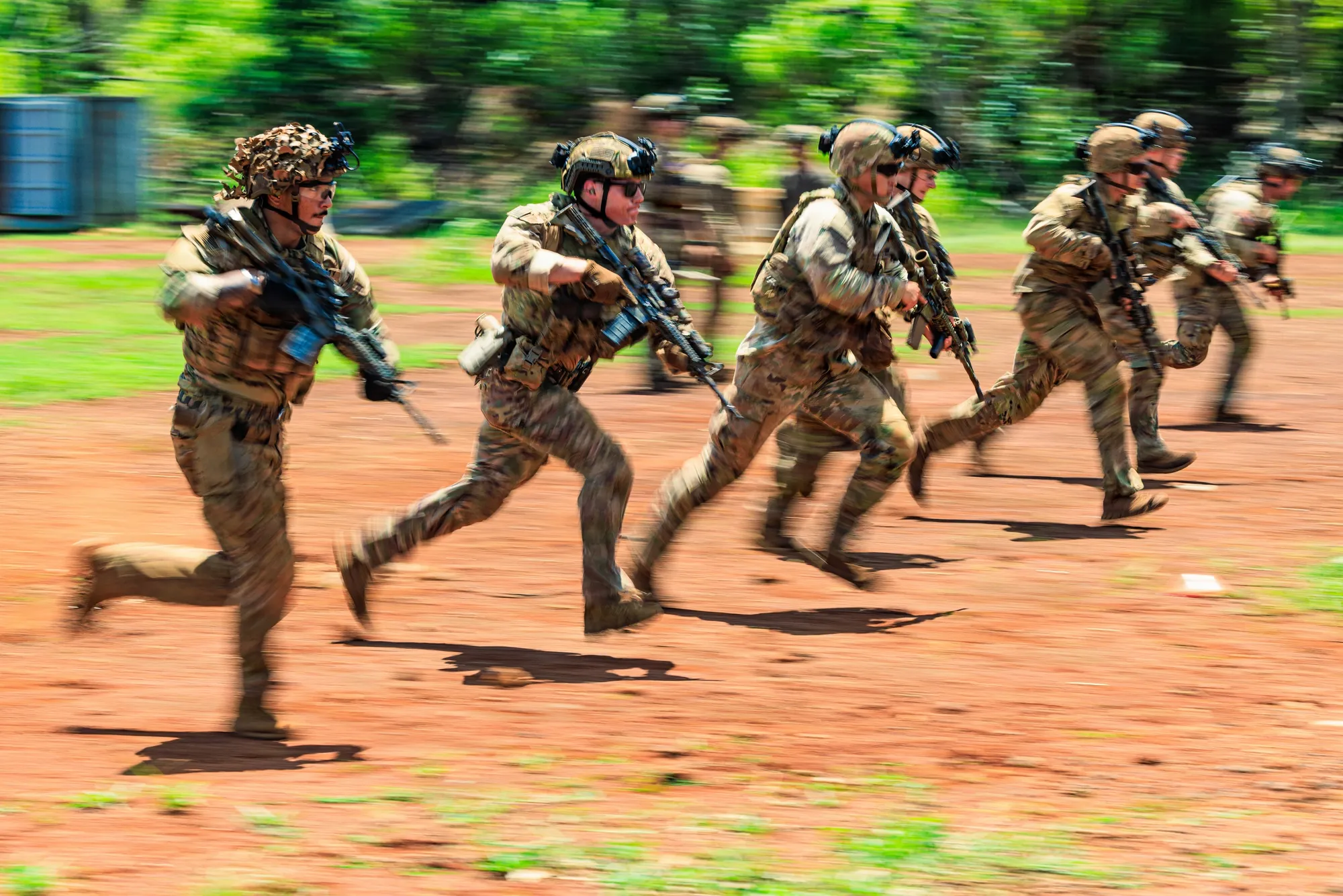 Soldiers of the 25th Infantry Division sprinting between firing positions on a live-fire range